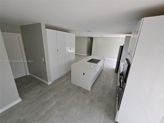 kitchen with sink, a wealth of natural light, white cabinets, and appliances with stainless steel finishes