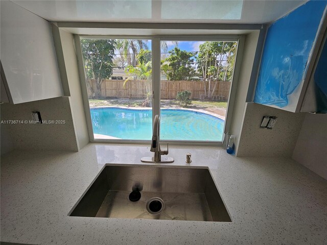 view of swimming pool with sink