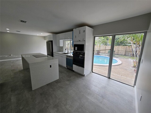 kitchen featuring sink and white cabinets