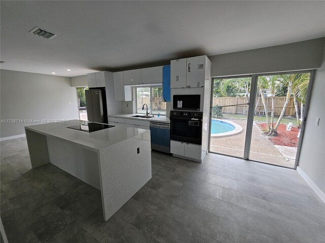 interior space featuring sink and white cabinets