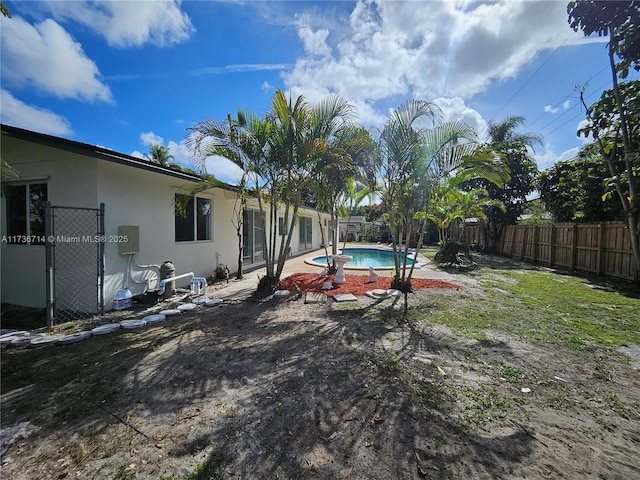 view of yard with a fenced in pool