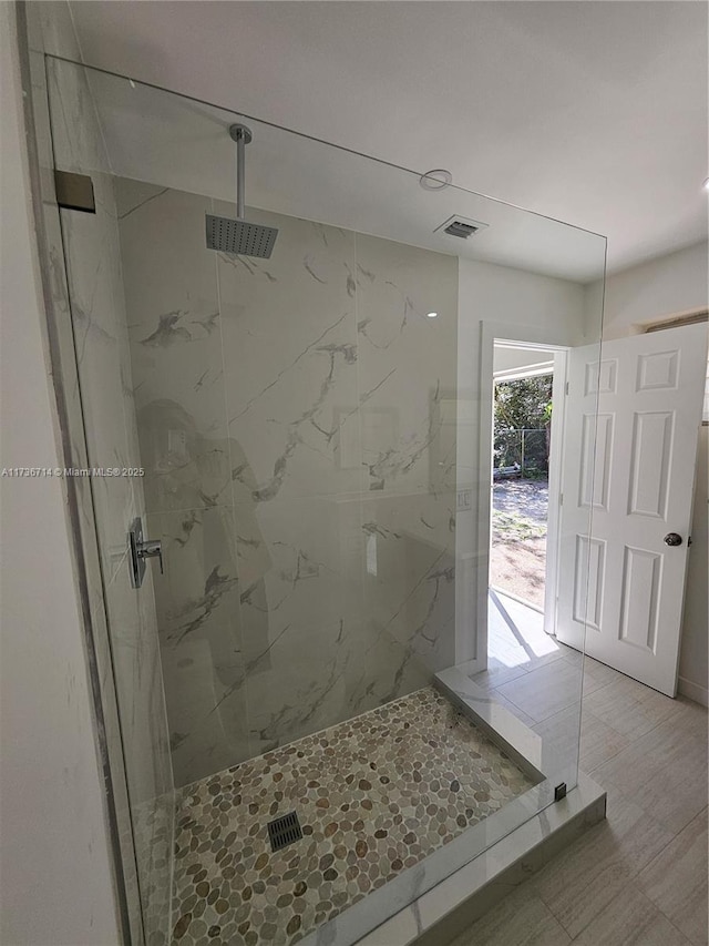 bathroom with a tile shower