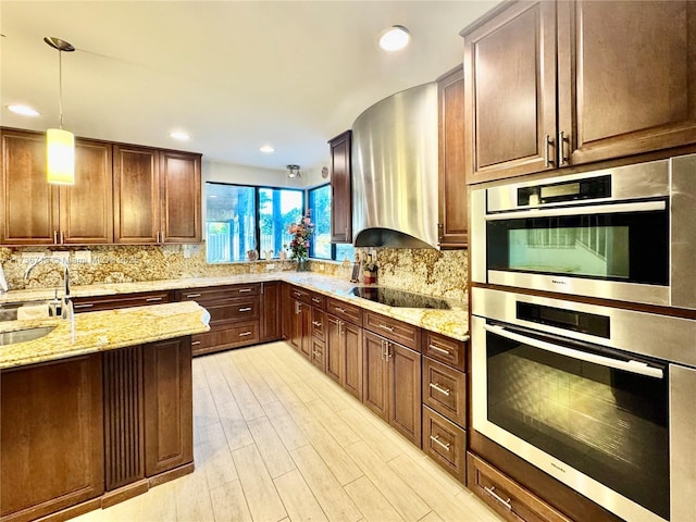 kitchen featuring light stone counters, decorative light fixtures, decorative backsplash, stainless steel double oven, and black electric cooktop