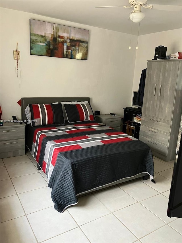 tiled bedroom featuring ceiling fan