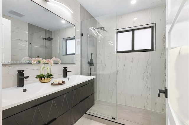 bathroom with plenty of natural light, vanity, and a tile shower