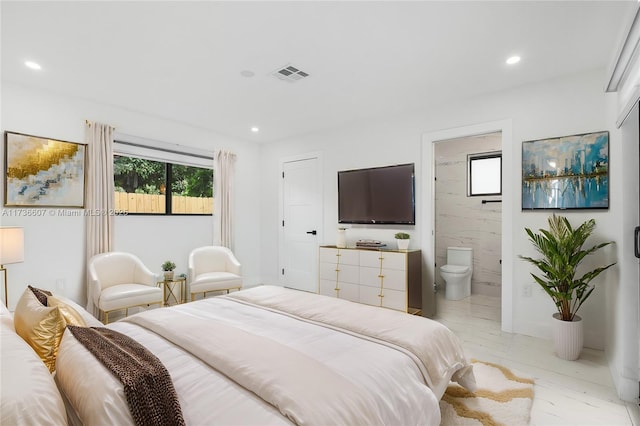 bedroom featuring multiple windows and ensuite bath