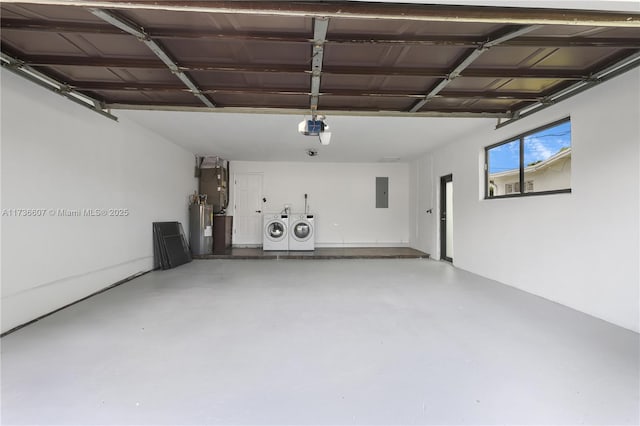 garage with water heater, a garage door opener, electric panel, and independent washer and dryer