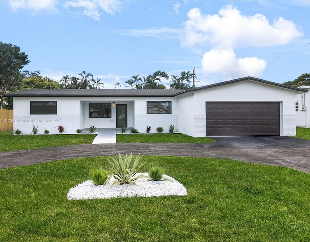 ranch-style house with a garage and a front yard