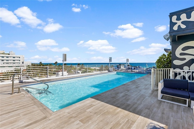 view of pool with a water view