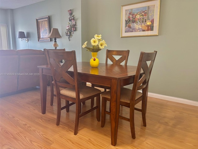 dining space featuring light wood-type flooring