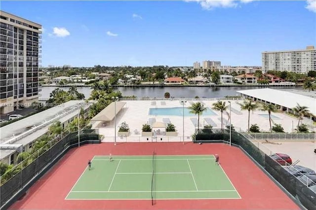 view of tennis court featuring a water view