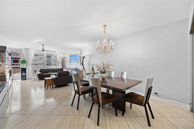 dining area featuring ceiling fan with notable chandelier, a textured ceiling, and light tile patterned floors