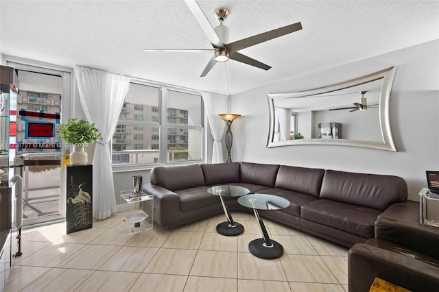 tiled living room featuring ceiling fan and a textured ceiling