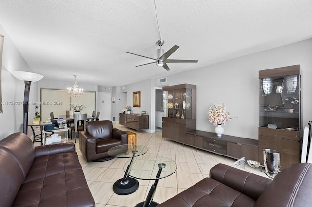 tiled living room with ceiling fan with notable chandelier and a textured ceiling