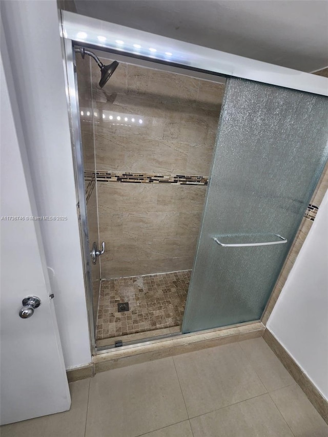 bathroom featuring tile patterned floors and an enclosed shower