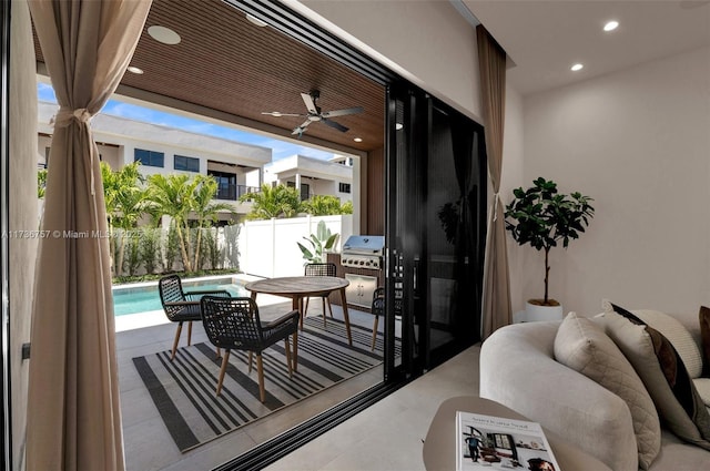 balcony with a patio and ceiling fan