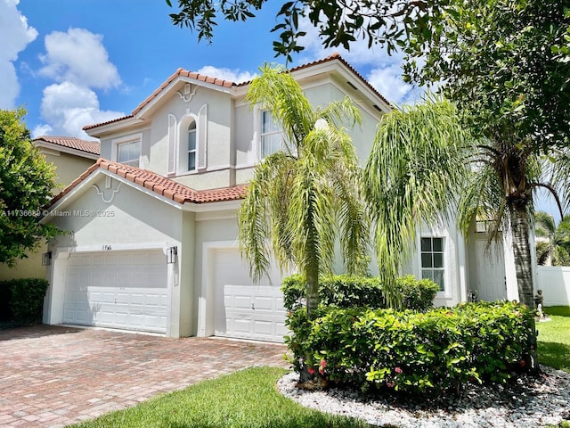 mediterranean / spanish-style home with a garage