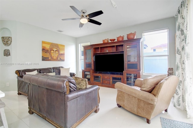 living room featuring ceiling fan and light tile patterned flooring