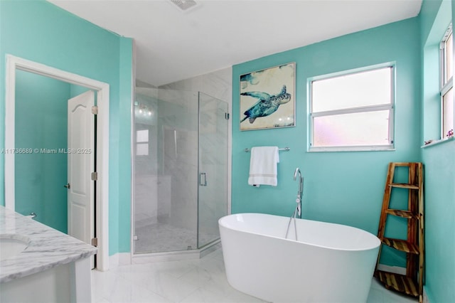 bathroom featuring vanity and shower with separate bathtub