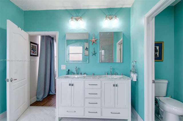 bathroom featuring vanity and toilet