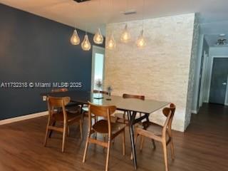 dining space featuring dark hardwood / wood-style floors