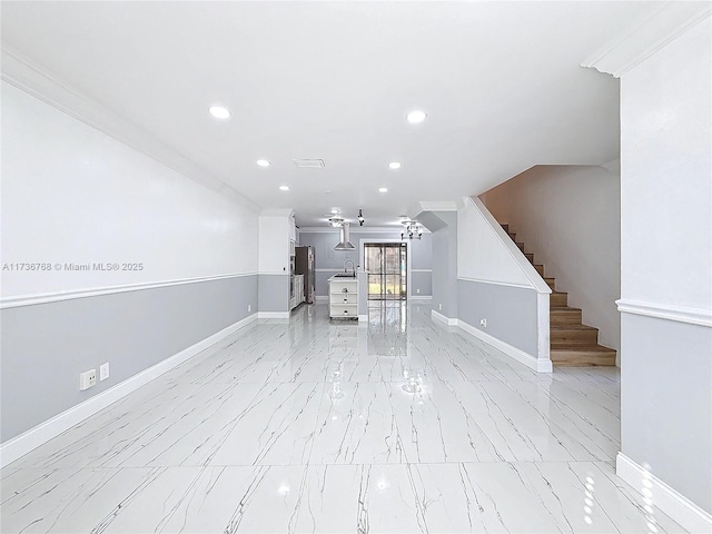 unfurnished living room with ornamental molding