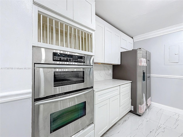 kitchen featuring stainless steel appliances, ornamental molding, white cabinets, and electric panel