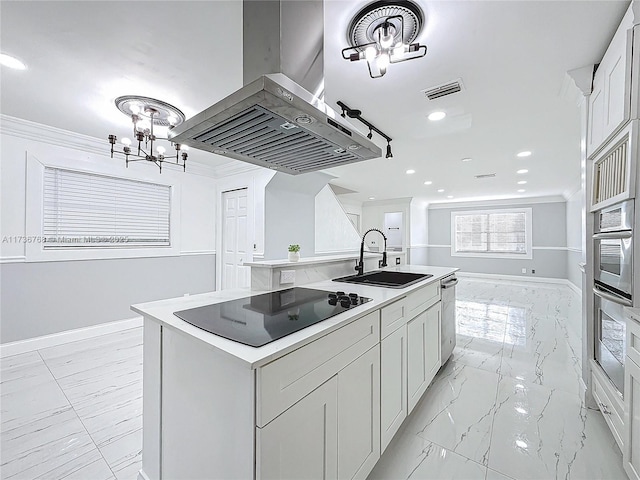 kitchen featuring sink, stainless steel appliances, island range hood, white cabinets, and a center island with sink