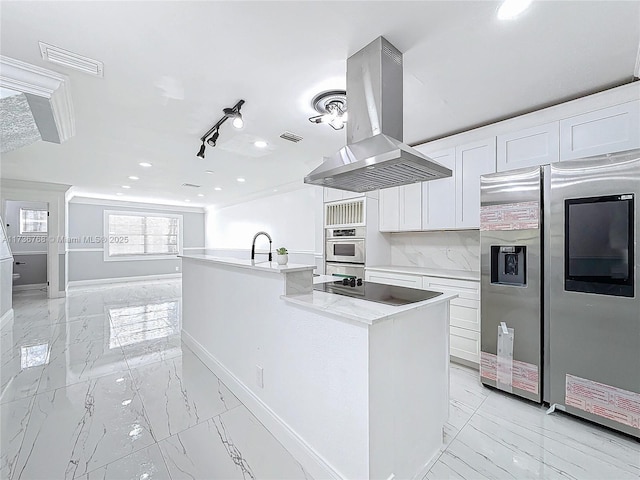 kitchen featuring stainless steel appliances, island exhaust hood, a center island with sink, and white cabinets