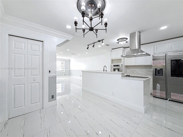 kitchen with island range hood, an island with sink, white cabinets, a notable chandelier, and stainless steel appliances