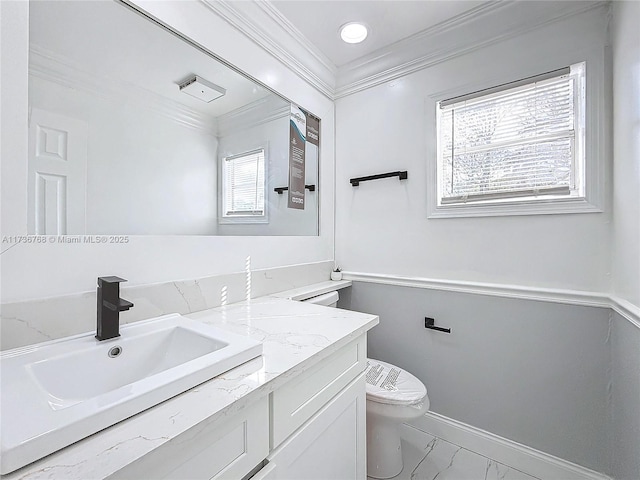 bathroom with vanity, ornamental molding, and toilet