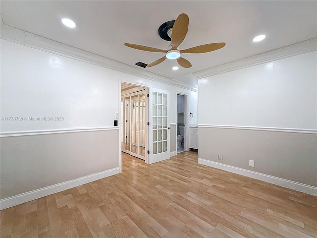 empty room with ceiling fan, ornamental molding, and light hardwood / wood-style floors