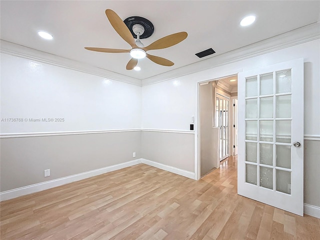 spare room featuring ornamental molding, ceiling fan, and light wood-type flooring