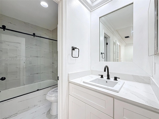 full bathroom with bath / shower combo with glass door, vanity, and toilet