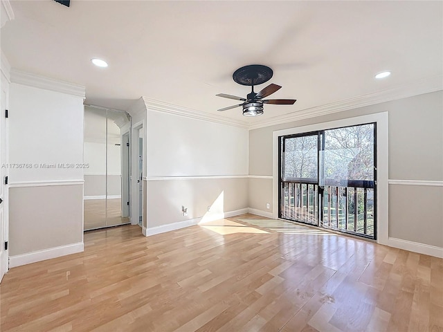 spare room featuring ornamental molding, ceiling fan, and light wood-type flooring