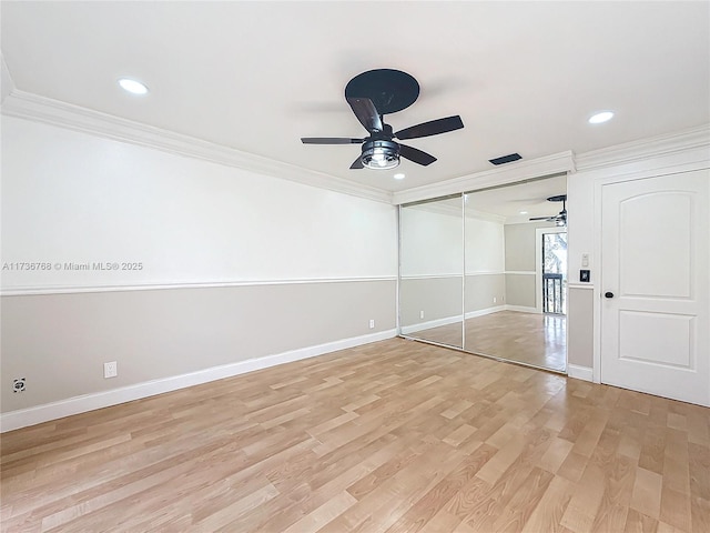 unfurnished bedroom featuring crown molding, light hardwood / wood-style flooring, a closet, and ceiling fan