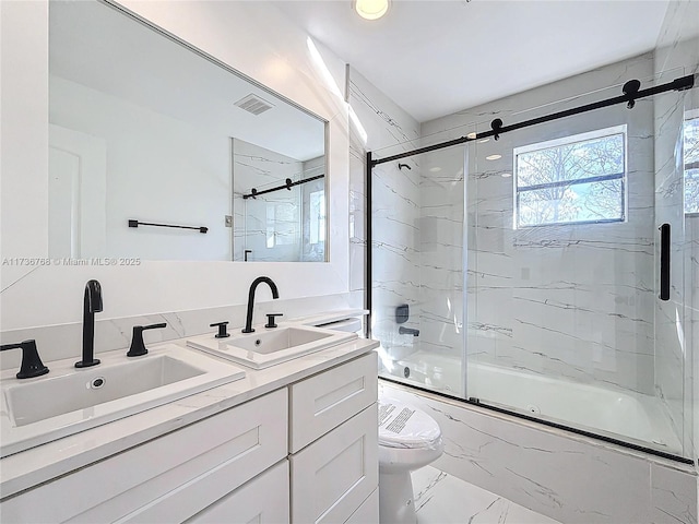 full bathroom featuring vanity, toilet, and combined bath / shower with glass door