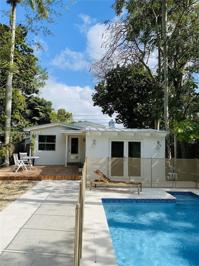 view of swimming pool featuring a wooden deck and a patio