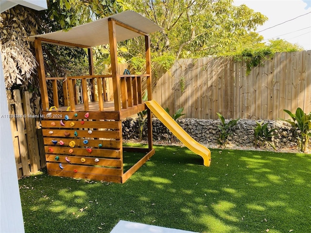 view of playground with a yard