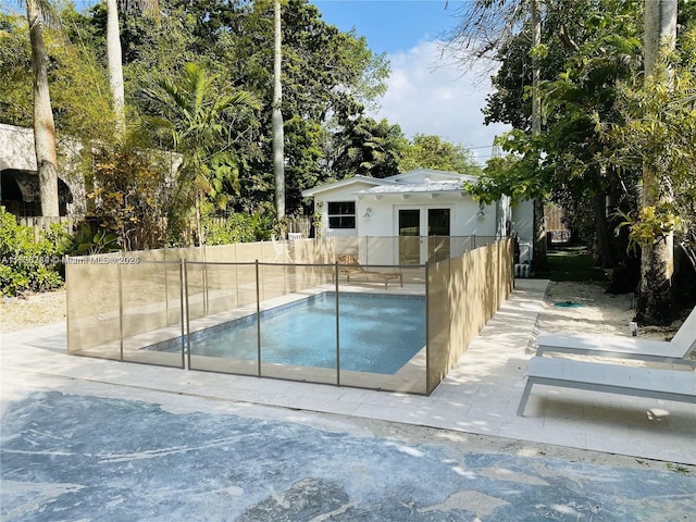 view of swimming pool with an outdoor structure and a patio