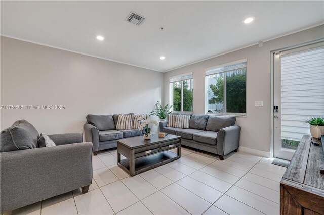 living room featuring crown molding and light tile patterned floors