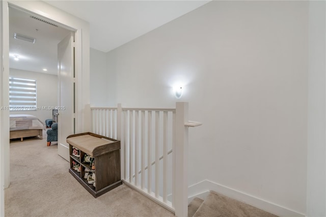 corridor with light colored carpet