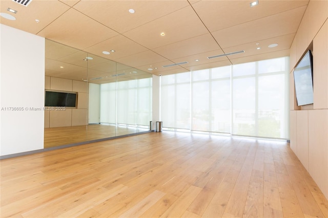 empty room featuring light hardwood / wood-style flooring and floor to ceiling windows