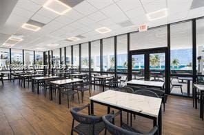 dining area with floor to ceiling windows, wood finished floors, and plenty of natural light