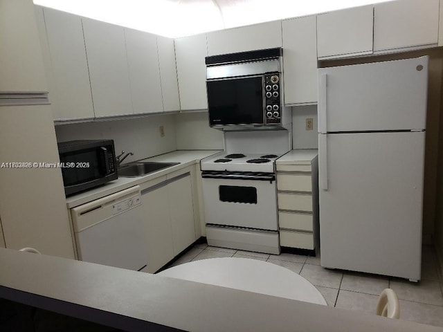 kitchen featuring sink, light tile patterned floors, white cabinets, and white appliances