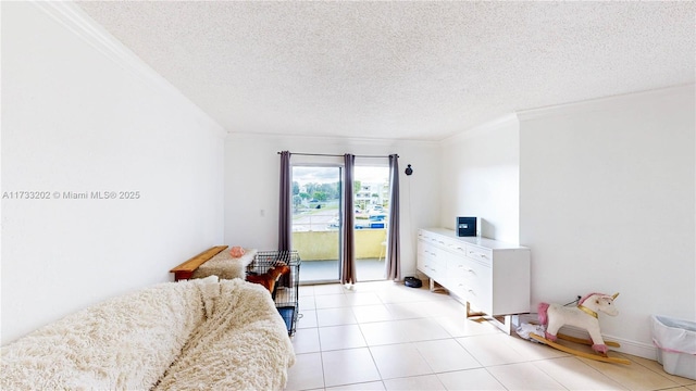 tiled bedroom with access to outside, ornamental molding, and a textured ceiling