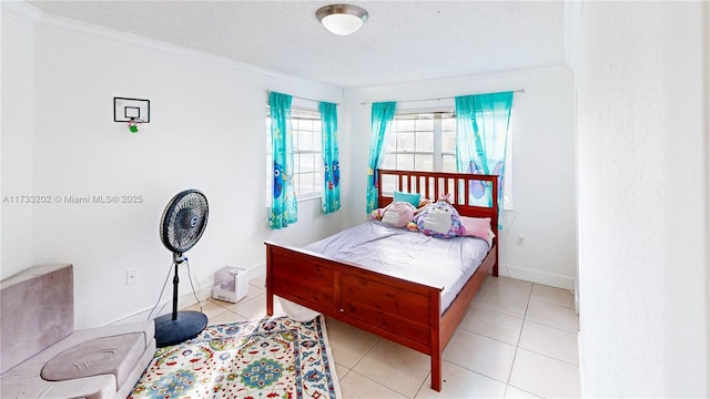 tiled bedroom with ornamental molding and a textured ceiling