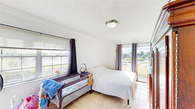 tiled bedroom featuring a textured ceiling