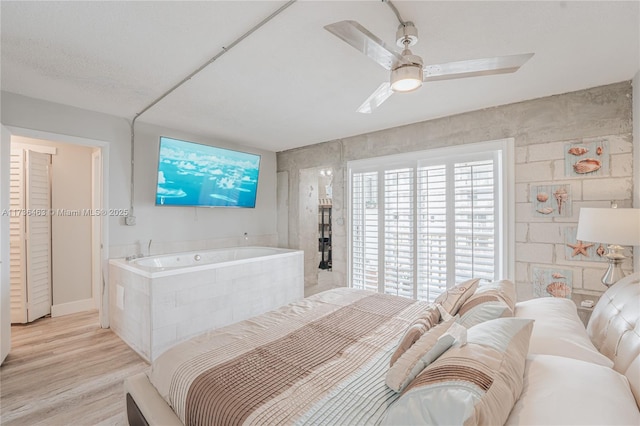 bedroom with ceiling fan and light hardwood / wood-style flooring