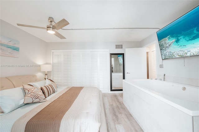 bedroom featuring light hardwood / wood-style floors and ceiling fan